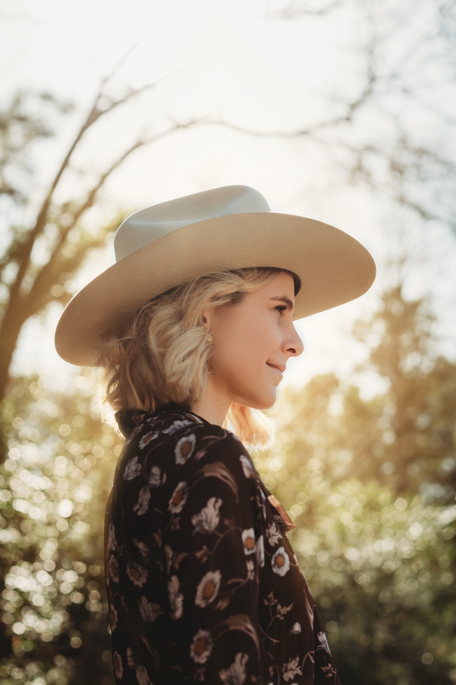 Hannah Marie in a cream cowboy hat, golden hour in the East Texas pines